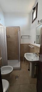 a bathroom with a shower and a sink and a toilet at Hotel Normanni in Praia a Mare +50 photos