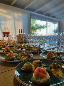 a row of plates of food on a table at Ayda Bağları Winery & Vineyards in Seferihisar