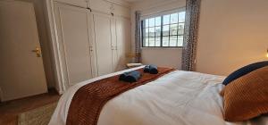 a bedroom with a large bed with a window at "Toca do Coelho" Charming Retreat close to Albufeira Beaches in Albufeira