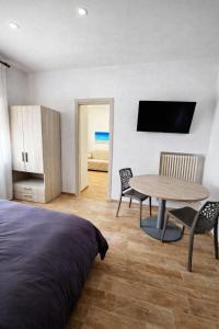 a bedroom with a bed and a table with chairs at Villa Merina in Vieste +12 photos