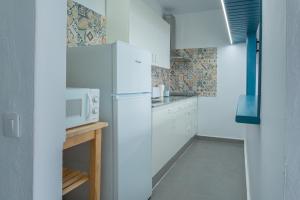 a kitchen with a refrigerator and a microwave at Vivienda Vacacional Tinisagua 3 in Breña Alta +11 photos