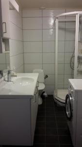 a white bathroom with a sink and a toilet at Bodø Apartment in Bodø