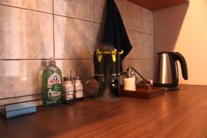 a counter top with a bottle of soap and utensils at Cozy Alauksta apartment in Riga