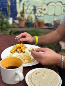 a person sitting at a table with a plate of food at Guest House Don Moisés in Copán Ruinas +30 photos