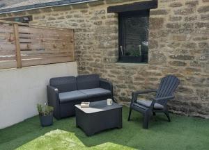 a patio with two chairs and a couch and a table at Studio 09 in Sulniac