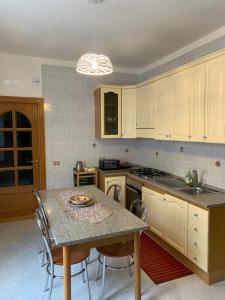 a kitchen with a table with chairs and a counter top at Casa Margherita in Minori