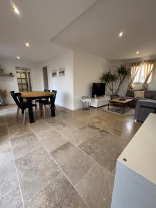a living room with a table and a couch at Maison 4 personnes in Saint-Julien