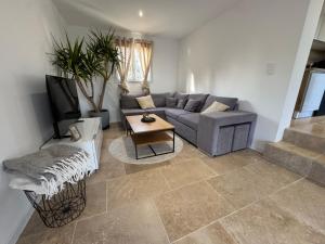 a living room with a couch and a table at Maison 4 personnes in Saint-Julien