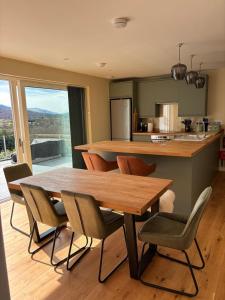 a kitchen with a wooden table and some chairs at Sunny Ridge in Fort Augustus