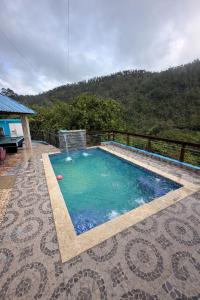 a swimming pool with a view of a mountain at Villa azul círculo auto in Jarabacoa