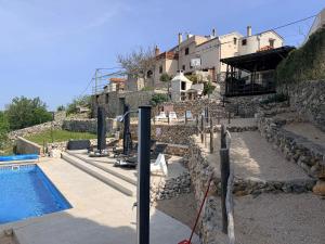 a villa with a swimming pool and a house at Vita Vacation Home in Ustrine