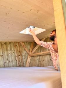 a man in a room with a ceiling fan at Cabane étape in Idrac-Respailles