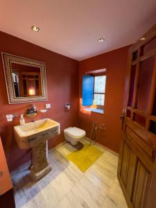 a bathroom with a sink and a toilet at Houch Ennejma in Al Ḩārah al Kabīrah +35 photos