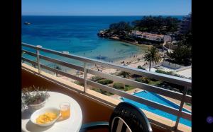 a balcony with a table and a view of the beach at Calpe vistas al mar in Ifach