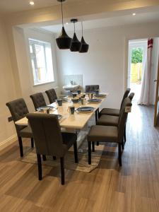 a dining room with a long table and chairs at Selsey Home in Selsey
