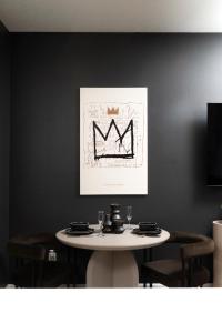 a dining room with a table and a crown painting at 3BR & 3BA Downtown Modern Artsy Home Fully Equipped with Patio in Tampa