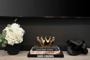 a book and a crown on a table with a flower at 3BR & 3BA Downtown Modern Artsy Home Fully Equipped with Patio in Tampa +34 photos