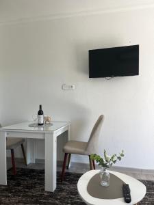 a room with a table and a television on a wall at White Rose 2 in Bar