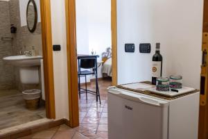 a room with a bottle of wine on top of a refrigerator at La Venere in Taormina +58 photos