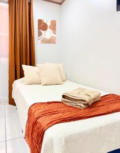 a bedroom with a bed with towels on it at Apartamento #10 in Alajuela