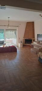 a large room with a bed and a fireplace at Agios Stefanos TwoStory Maisonette in Néa Zoryiáni