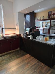 a restaurant kitchen with a counter with a counter at DAD Vogelweiderhof Rooms in Salzburg