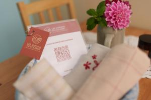 a card sitting on a table next to a vase with a flower at Les Jardins de Colmar in Herrlisheim-près-Colmar +9 photos