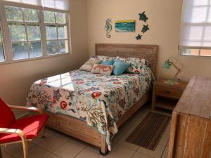 a bedroom with a bed and a table at A Private Paradise by the Rainforest in Luquillo +50 photos