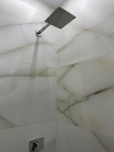a bathroom with a white marble ceiling and a shower at Luxury Studio in 6october in 6th Of October +9 photos