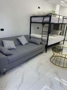 a living room with a couch and a bunk bed at Luxury Studio in 6october in 6th Of October