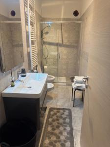a bathroom with a sink and a shower and a toilet at Suite Vittoria in Ortona +12 photos
