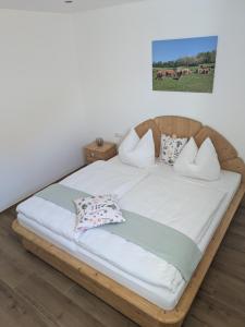 a wooden bed with pillows on it in a room at Brunner Alm in Obertaufkirchen