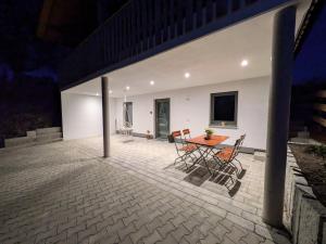 a patio with a table and chairs on it at Brunner Alm in Obertaufkirchen