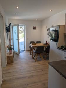 a kitchen and dining room with a table and a dining room at Brunner Alm in Obertaufkirchen