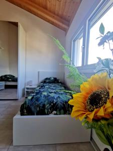a bedroom with a bed with a sunflower on it at Ca Mea - Lake View, Parking, EV in Gordola
