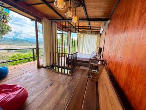 a room with a balcony with a bed and windows at Victoria Sky Crest - Kandy in Teldeniya +12 photos