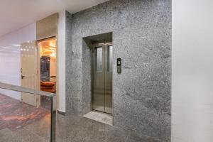 a hallway with a metal elevator in a building at Treebo Sloka Residency in Rānchī +26 photos