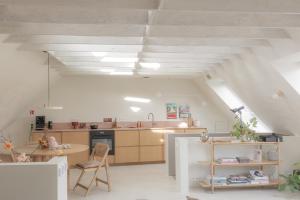 an attic kitchen with a table and a counter at CODAK suite in Kluisbergen
