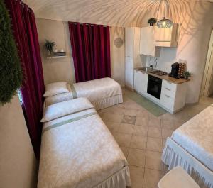a hotel room with two beds and a kitchen at Pino Center in Pino Torinese