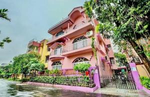 a pink building on the side of a river at ADRIJA Ck 140 Saltlake SEC-ll in kolkata