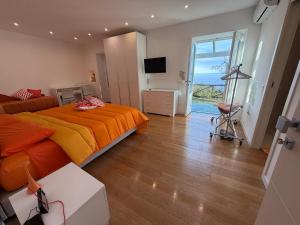 a bedroom with a bed with an orange bedspread at Villa Ice Sorrento in Sorrento