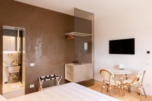 a bedroom with a bed and a table with chairs at Terra d'Ombra Bed&Breakfast in San Gimignano