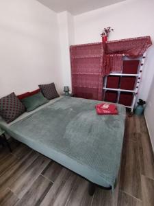 a bedroom with a bed with a red blanket at Casa Flamenca in Granada