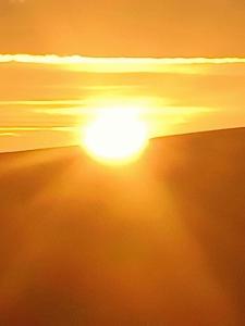 a sunset on the beach with the sun in the sky at Bay View Porlock Bed & Breakfast in Porlock +16 photos