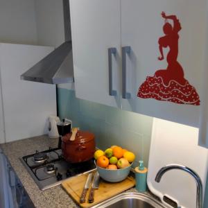 a kitchen with a bowl of fruit on a cutting board at Casa Flamenca in Granada +6 photos