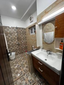a bathroom with a sink and a mirror at Ranim Family Lodge - Abbottabad in Abbottabad +34 photos