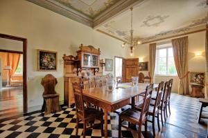 a dining room with a wooden table and chairs at Villa Fiamma by PosarelliVillas in Piaggiori