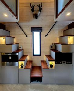 a room with wooden walls and a window and benches at Tiny House Annecy in Annecy