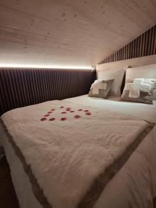 a bedroom with a bed with red roses on it at Tiny House Annecy in Annecy