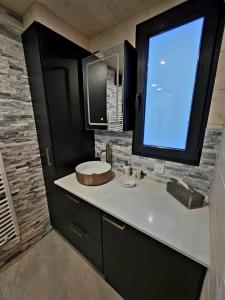 a bathroom with a sink and a large window at Tiny House Annecy in Annecy